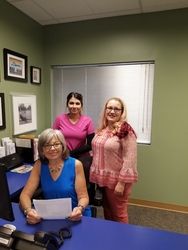 Three New Mexico Smile Center staff members standing in office.